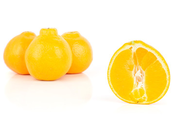 Group of three whole one half of fresh orange tangelo minneola isolated on white background
