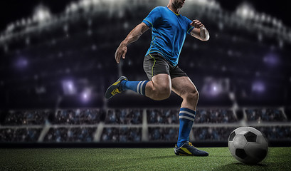 Football player with ball on field of stadium