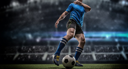 Football player with ball on field of stadium