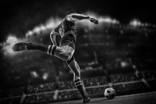 Football player with ball on field of stadium