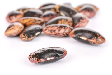 Lot of whole stained purple bean isolated on white background