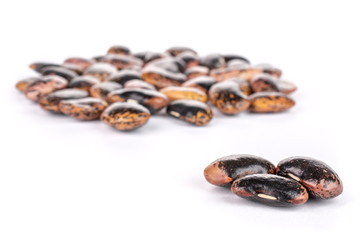 Lot of whole stained purple bean isolated on white background