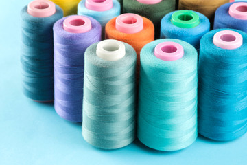 Accessories for sewing and needlework. Many multi-colored spools of thread. Bobbins with colored thread