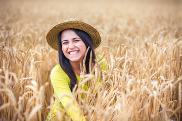 portrait of the rural girl in a straw hat