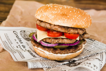 delicious burger with cucumber and onions