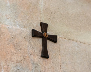 Wooden cross with number 9 - the ninth stop of the Way of the Cross on the wall catholic Christian...