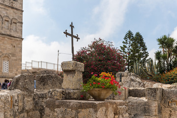Metal cross on the ruins of the temple of Byzantine times in the territory catholic Christian Transfiguration Church located on Mount Tavor near Nazareth in Israel