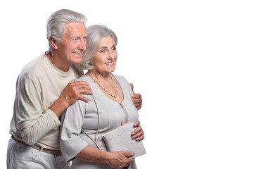 Happy senior couple posing on white background