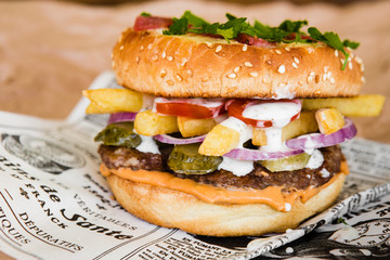 delicious burger with cucumber and onions
