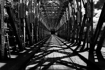 Monochrome road on the bridge immersed in light and shade.