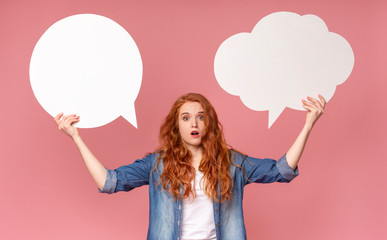 Redhead girl holding two speech bubbles having complex choice