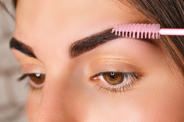 Young woman with beautiful eyebrows after correction, closeup