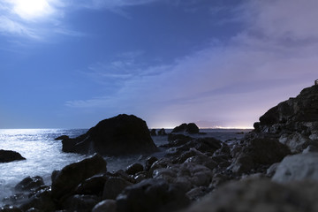 Fototapeta na wymiar Seaside landscape in the night with rocks