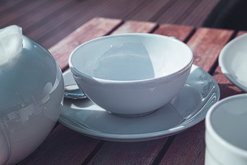 white empty dishes on a table in a restaurant