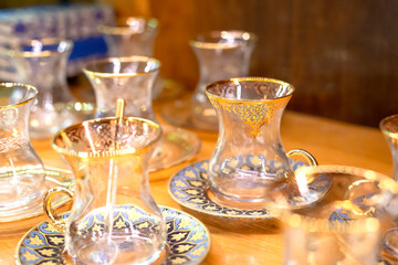Traditional famous turkish tea cup with plate on the shelf in the shop. One of the most popular souvenir from Istanbul, Turkey.  