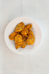 Chicken Wings Spicy chicken wings, breaded, fried, cooked.