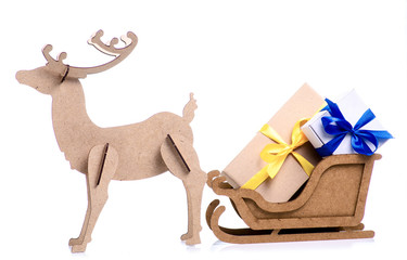 Wooden christmas deer, sleigh with gift boxes on white background isolation