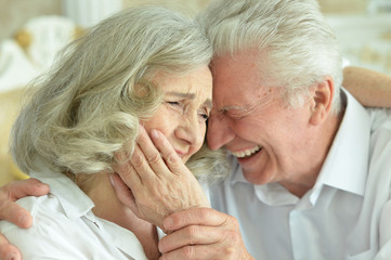 Portrait of happy beautiful senior couple posing at home
