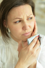 Portrait of sad young woman posing at home