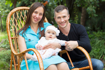 Obraz premium Family portrait mom dad and little baby. Parents with baby