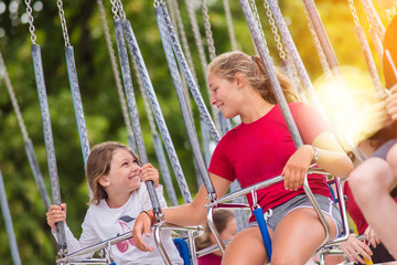 young girl in carousel to have thrills