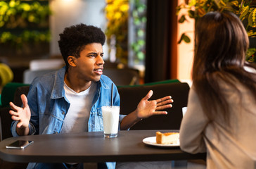 Mad young black guy shouting at his girlfriend