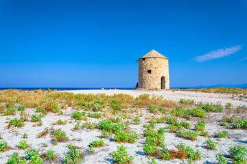 Famous Gyra beach with old windmills in Lefkada island, Greece.