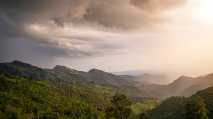 Rain on the mountains with warm light.