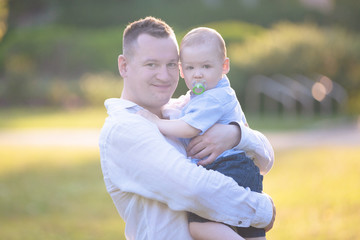 Portrait of a father with his son on his hands