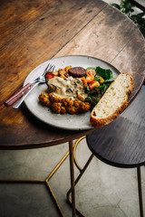Warm hearty breakfast, lunch with organic farm curry veggies. Wood table. Slow food living concept, close up, food photography from above