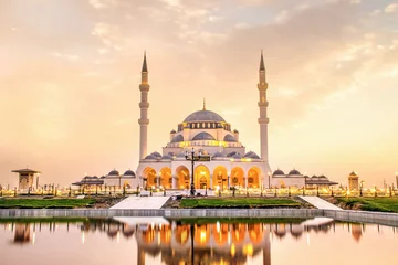Deurstickers Sharjah Mosque beautiful sunset view second biggest mosque in United Arab Emirates beautiful traditional Islamic architecture new tourist attraction in Middle east © sarath