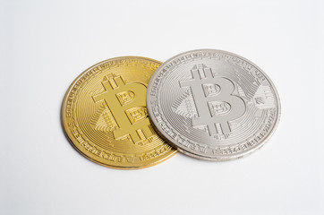 Two bitcoin on on white background. digital cyber safety or security encryption. Manage bitcoin price schedule concept. Money laundering bitcoin concept. Market Manipulation.