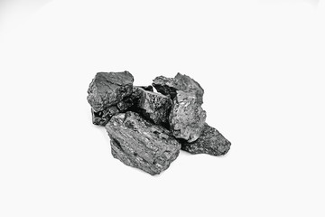 Pieces black coal lie on white isolated background, copy space