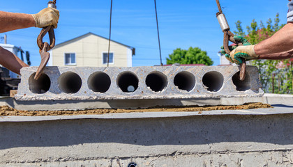 A crane raised a concrete slab at a construction site at home