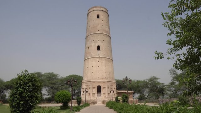 Sheikhupura Hiran Minar Frontal View of the Minaret with Flying Birds on a Sunny Blue Sky Day