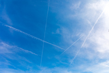 Bright blue sky with the many inversion tracks from aircrafts