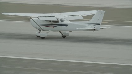 Small generic private propeller airplane preparing for landing, no tail or identification number. 60 FPS Slow Motion, 4K RAW graded footage