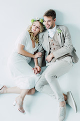 attractive bride and handsome bridegroom hugging and looking away