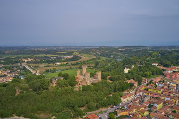 Obraz premium Castello scaligero in the town of Valeggio sul Mincio. The historic Ponte Visconteo Bridge was built in 1395 on the Mincio River. Aerial view. Flying on drone.