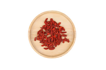 Dried goji berries in wooden plate isolated on white background.top view
