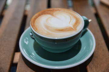 A cup of cappuccino coffee with latte art.Beautiful foam, vintage ceramic cup.