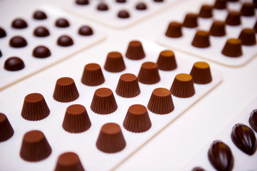 chocolate candies on a white surface. Selective focus