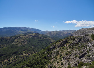 Fototapeta na wymiar Looking east from the Del Guarda Forestal Viewpoint at the Mountains and Ridgelines of the Sierra de Las Nieves National Park in Andalucia.