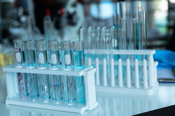 In lap at school,university,science chemistry concept. Laboratory test tubes and flasks with color liquid put on white table for work,check and test chemistry.
