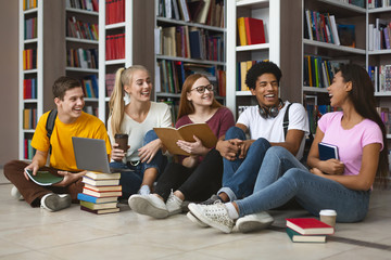 Five international students laughing at university library