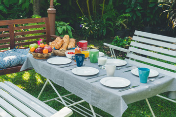 Breakfast table with food in the garden