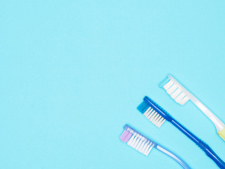 Toothbrushes on blue background with copyspace. Dental care concept