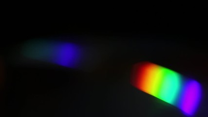 abstract multicolored light leaks on a black background.
