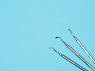 Dental instrument on blue background with copy space. Dental care concept