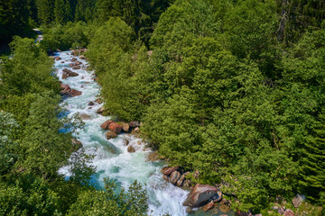 Mountain cold fresh water turquoise color of the Alpine mountains. Photo taken at long exposure.